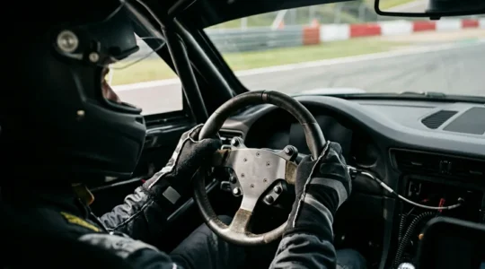 Pilote concentré au volant sur circuit automobile, expérience immersive de conduite sportive